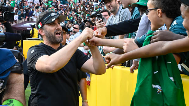 Philadelphia Eagles head coach Nick Sirianni celebrates with fans after the game against the Washington Commanders at FedExField.